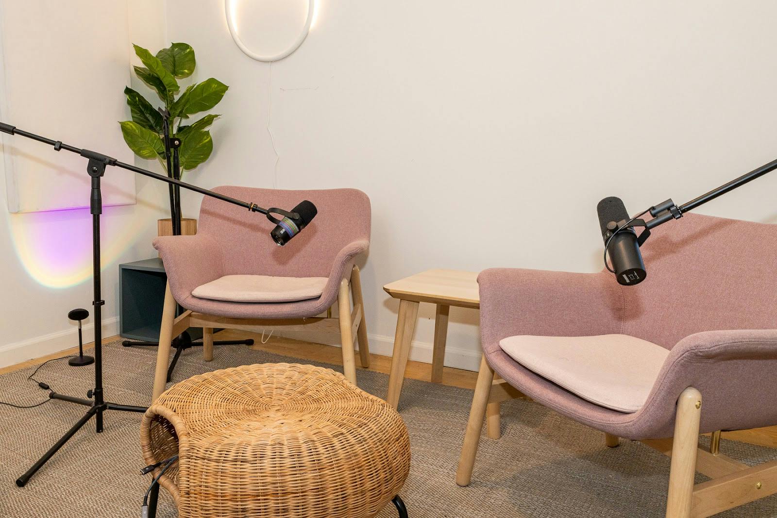 Cozy meeting space with soft seating and microphones for podcasts and discussions.