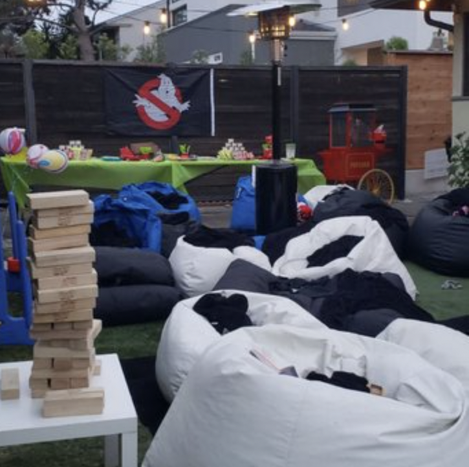 Bridal party in vibrant event space with bean bags for casual team-building fun.