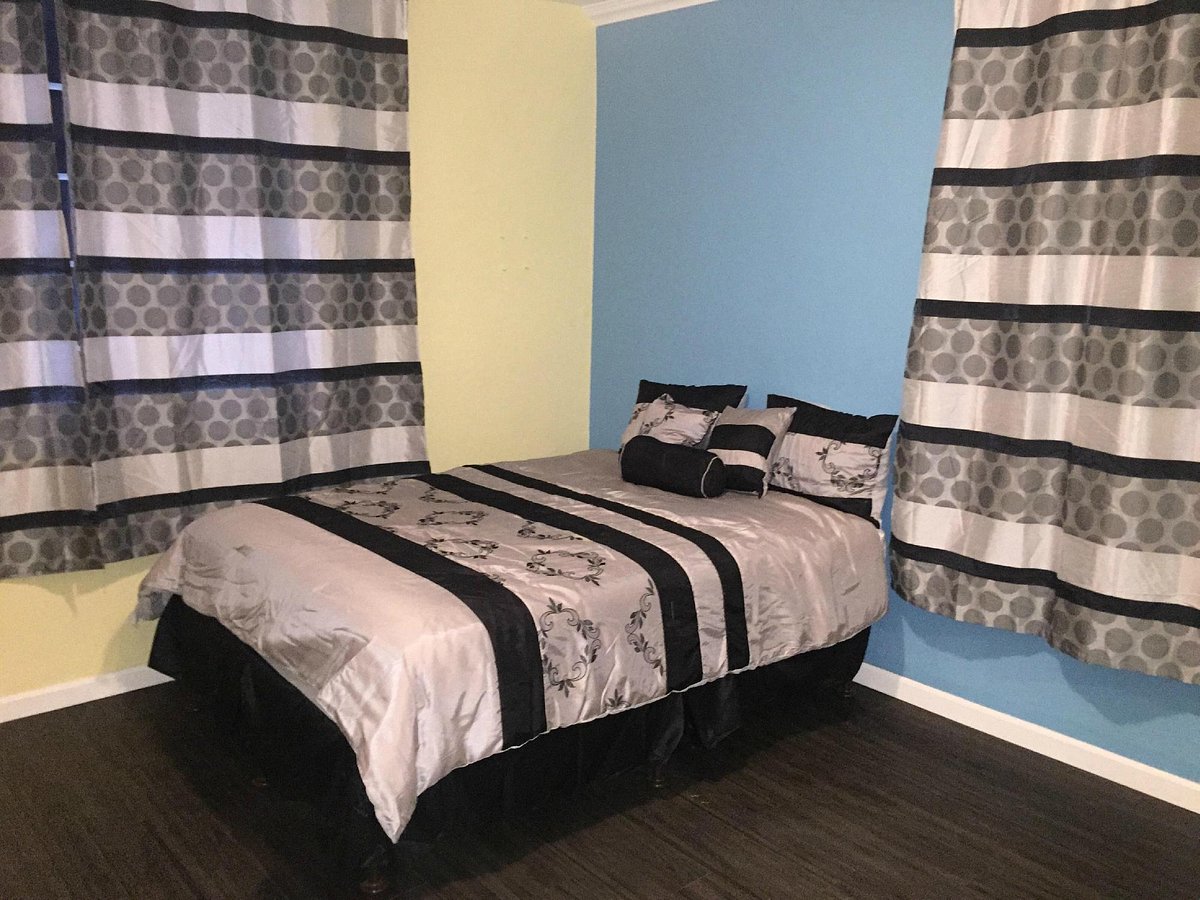 "Plaza Hotel Gardena guest room with calming decor for events and conferences."