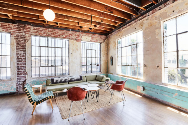 Stylish meeting space with large windows at FRANKIE Los Angeles, perfect for brainstorming sessions.