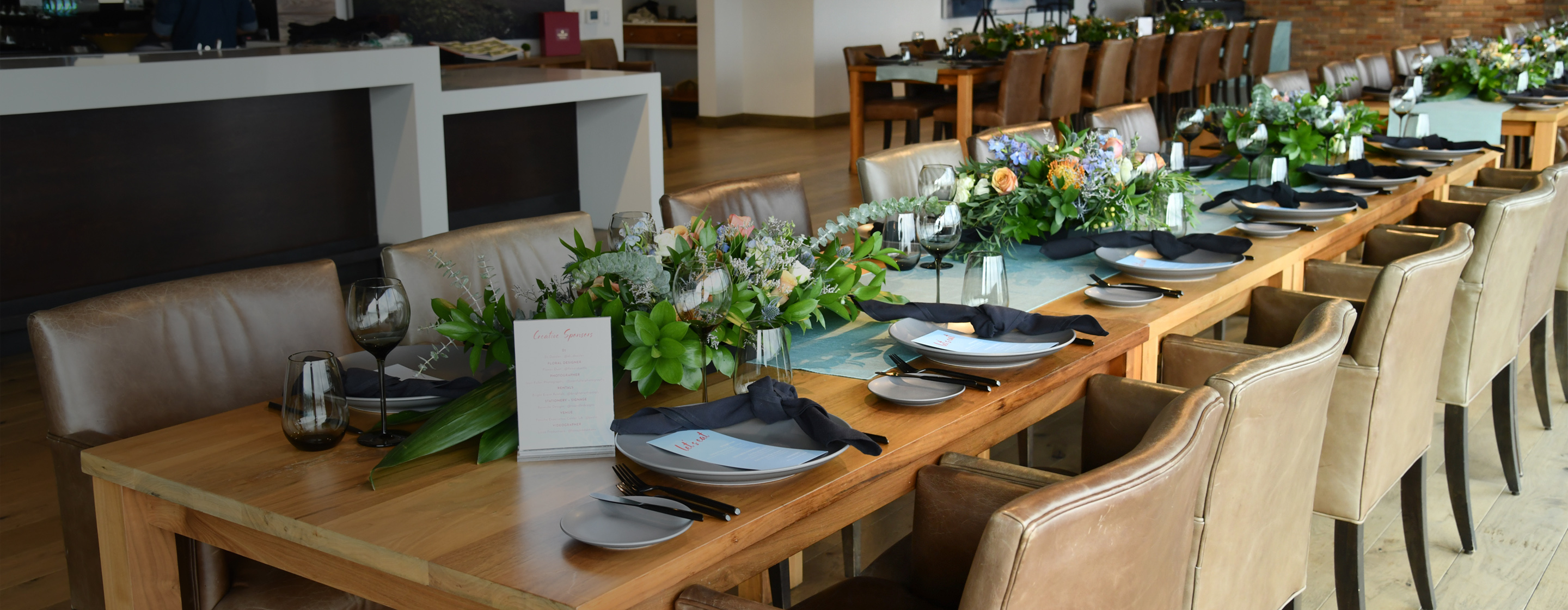 Elegant dining setup in Porsche Experience Center LA for sophisticated events.