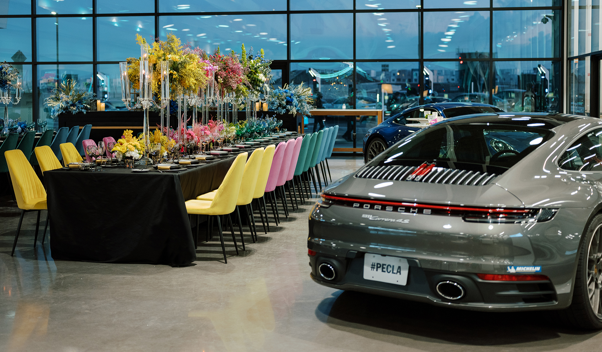 Porsche Experience Center event space with luxury decor and vibrant flowers for corporate gatherings.