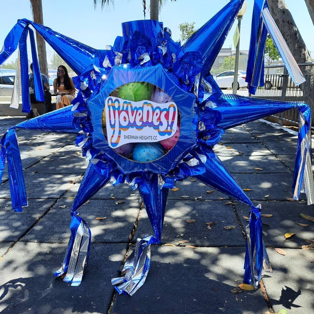 Vibrant blue star-shaped piñata at Sherman Heights Community Center event.