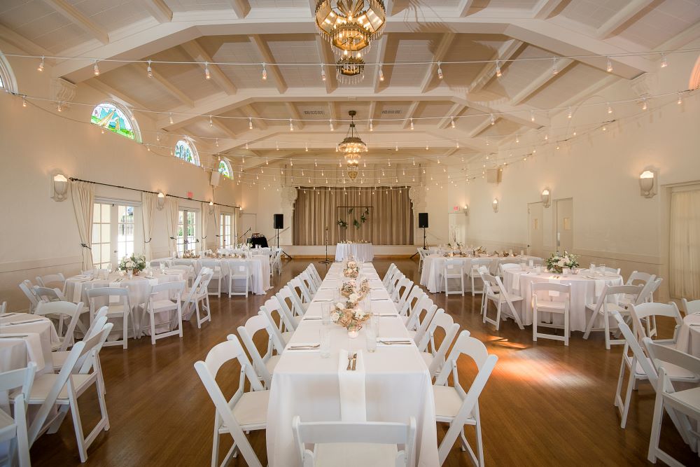 Elegant balcony event space with floral centerpieces, perfect for weddings and gatherings.