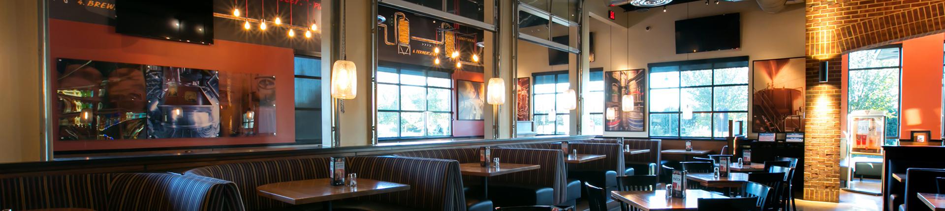 Modern dining area with booth seating at BJ's Restaurant & Brewhouse for casual events.