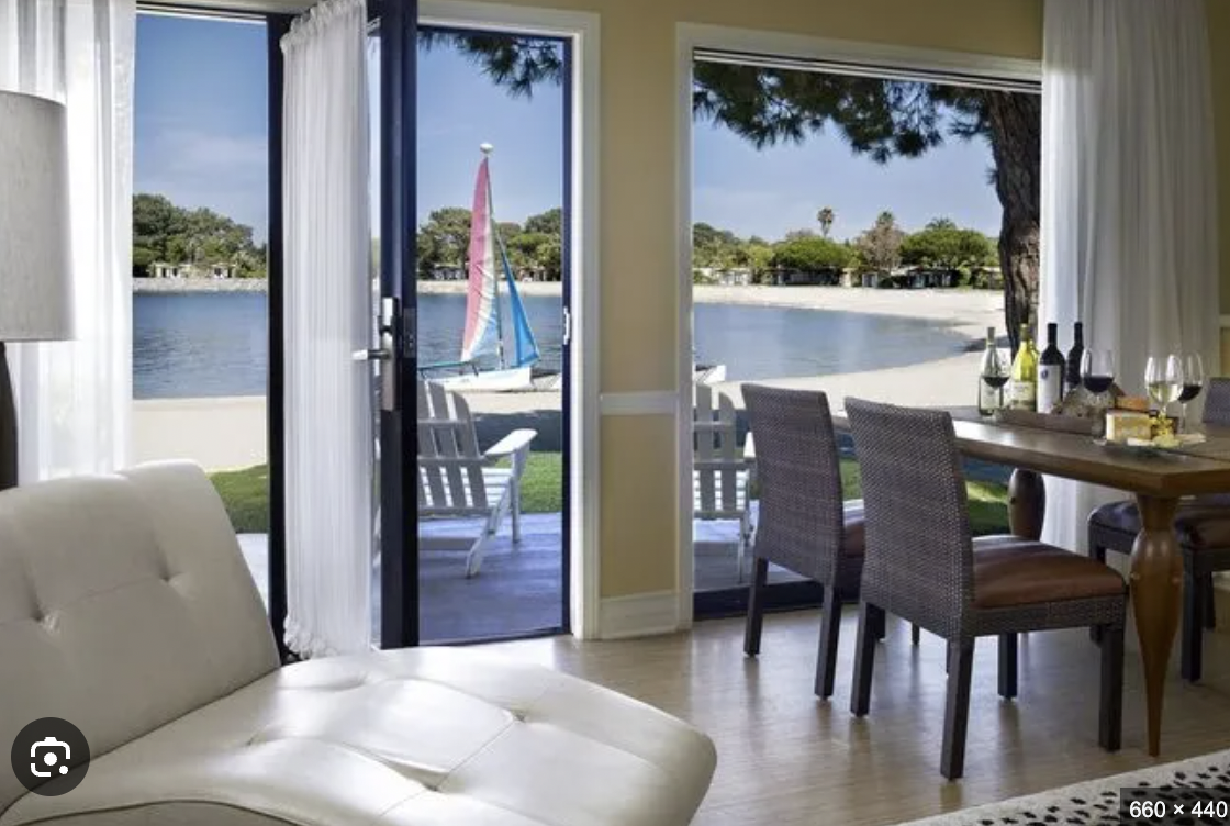 Serene waterfront venue with open doors, ideal for corporate retreats and events.