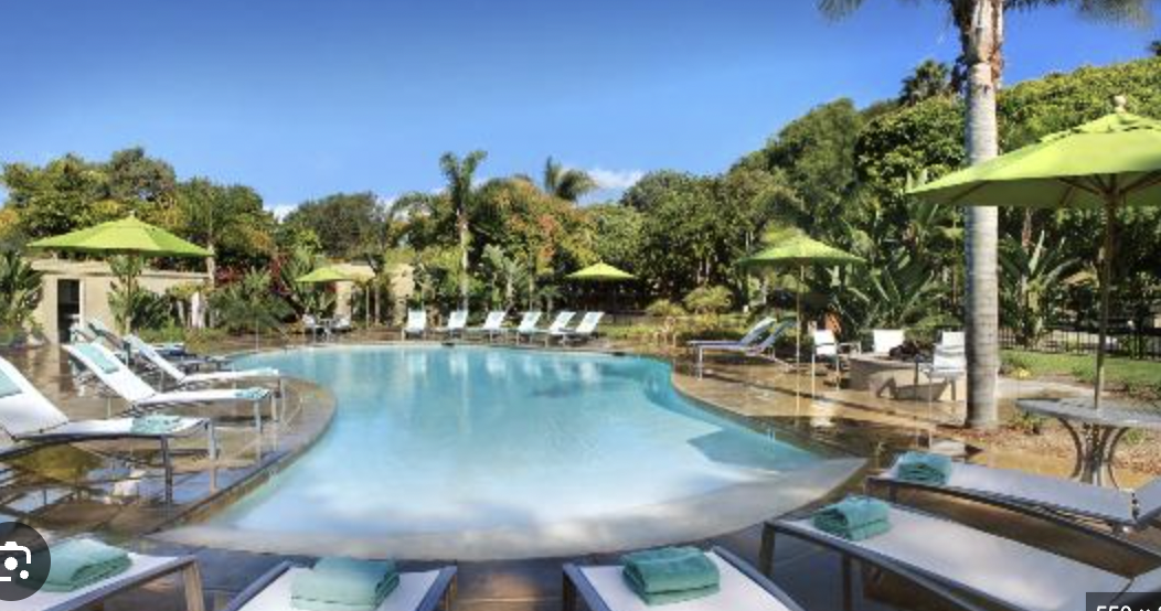 Lagoon Pool at The Point: serene venue with green umbrellas for outdoor events and retreats.