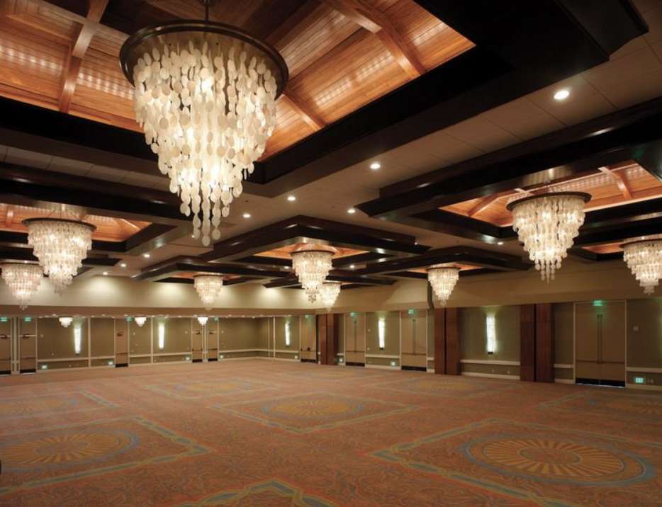 Elegant Sunset Ballroom venue with chandeliers, perfect for weddings and conferences.