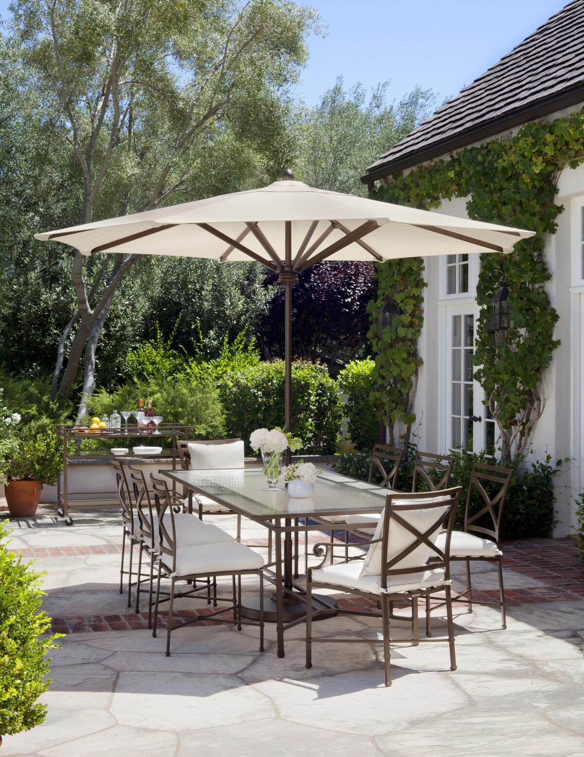 Elegant covered patio with spacious table, perfect for networking events and brunches.