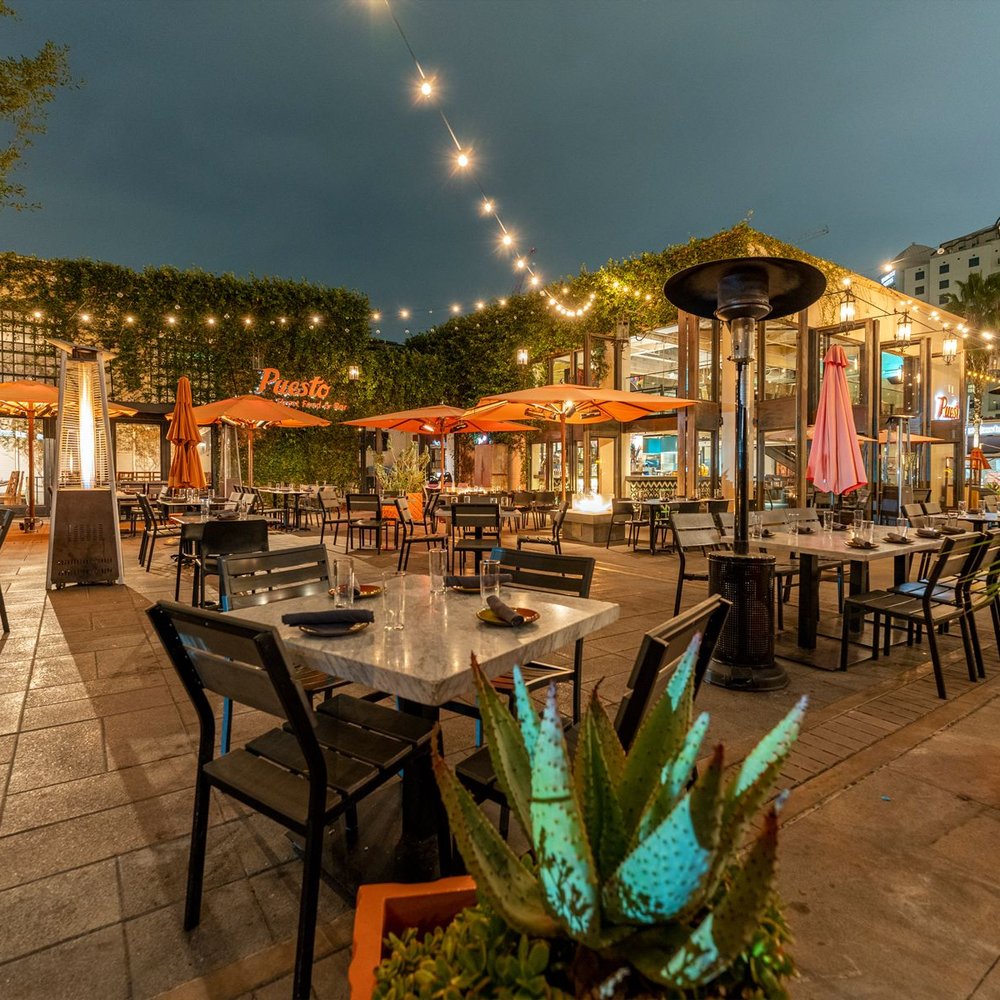 Covered patio with warm lighting, ideal for outdoor dining events and gatherings.