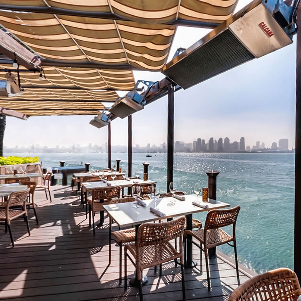 Elegant covered patio with waterfront view, ideal for cocktail receptions and intimate dinners.