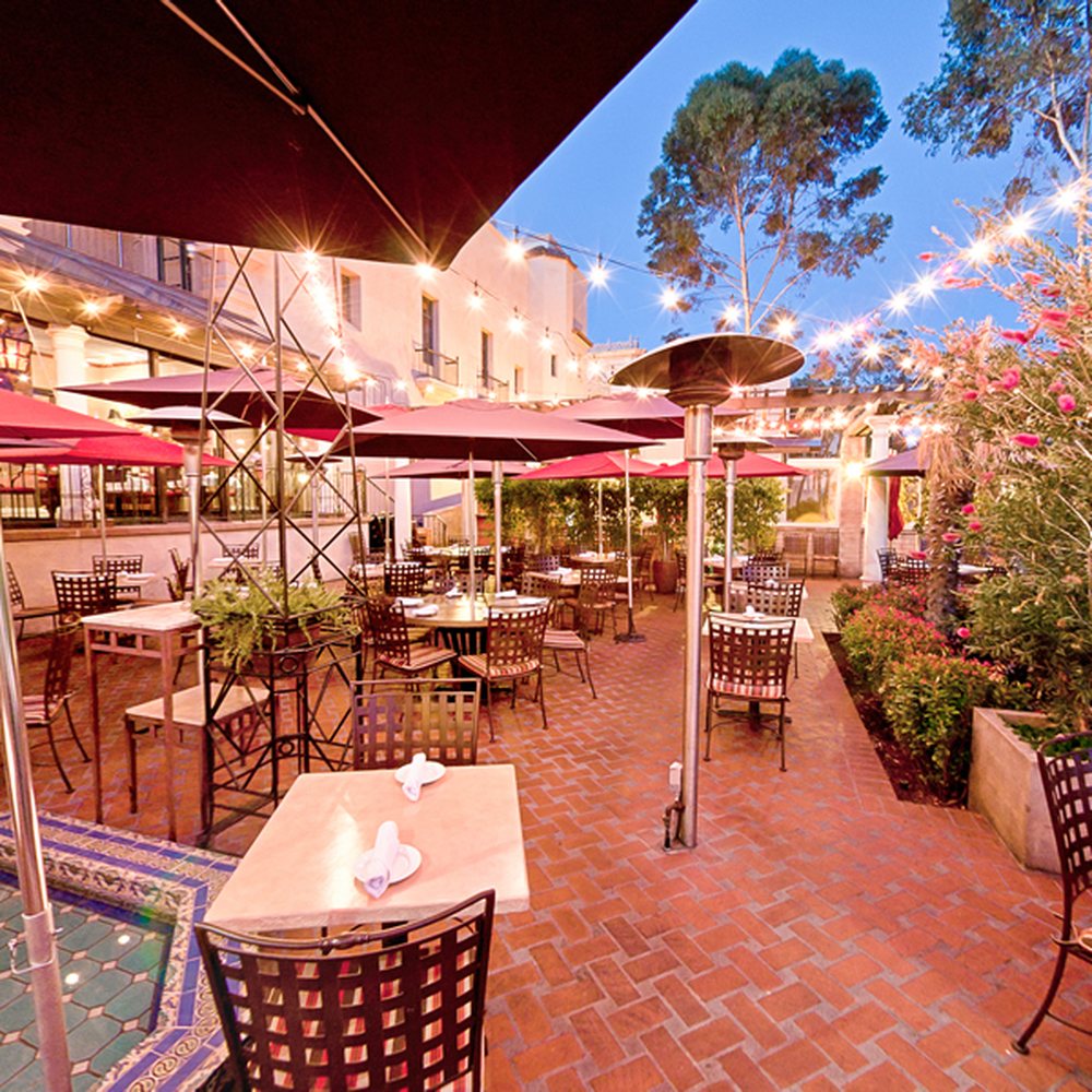 Charming covered patio with string lights, ideal for outdoor events and gatherings.