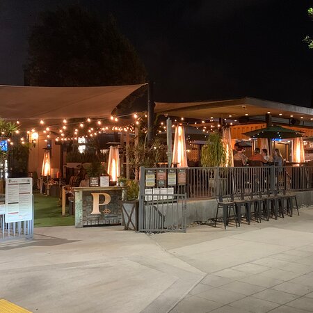 Vibrant outdoor venue with string lights for evening receptions and networking events.