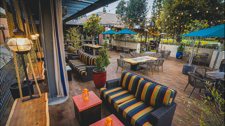 Vibrant outdoor event space with colorful seating and string lights for gatherings.