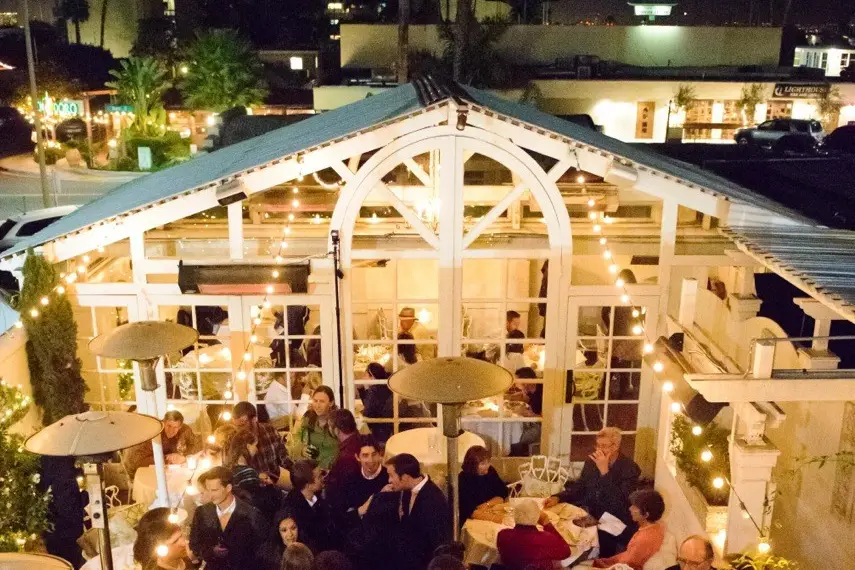 Chic Bar outdoor event space in Old Venice, warm lighting for gatherings and networking.