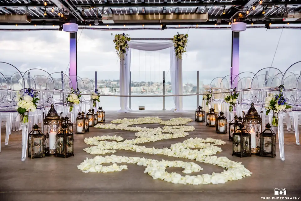 Skyline Terrace wedding setup with transparent chairs and floral arch, perfect for romantic ceremonies.