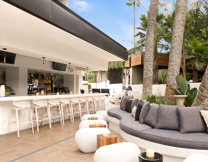 Stylish outdoor bar lounge with sleek seating, perfect for networking events and casual meetings.