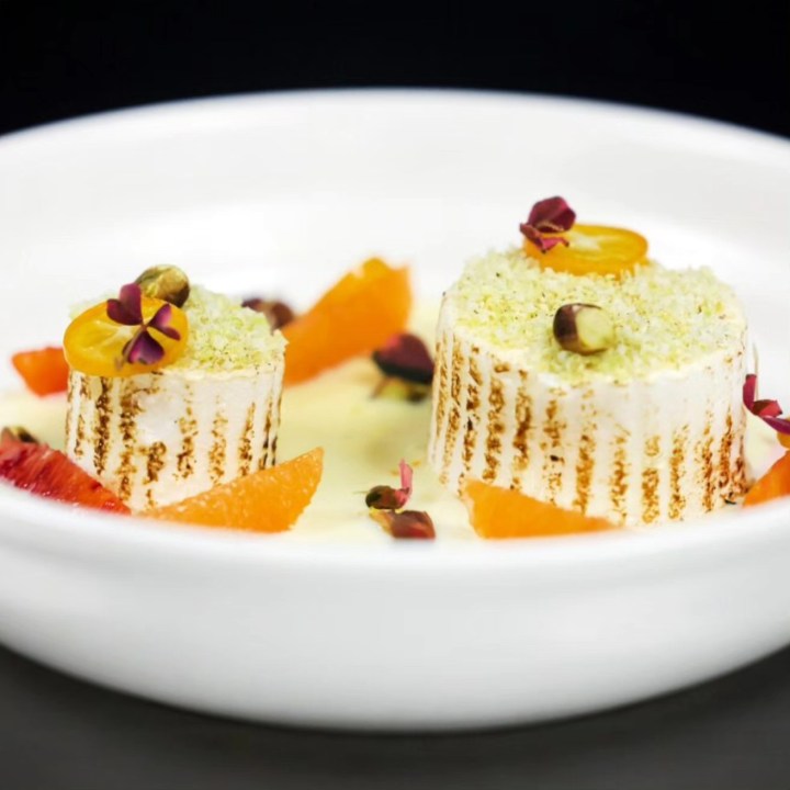 Elegant dessert mousse with citrus and flowers for upscale gala dining.