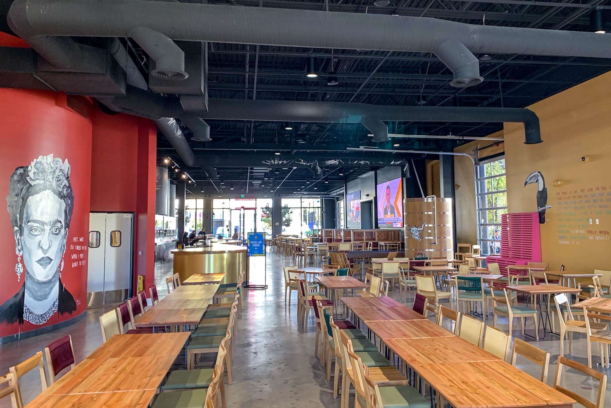Modern event space at Novo Brazil Brewing with vibrant decor and natural light.