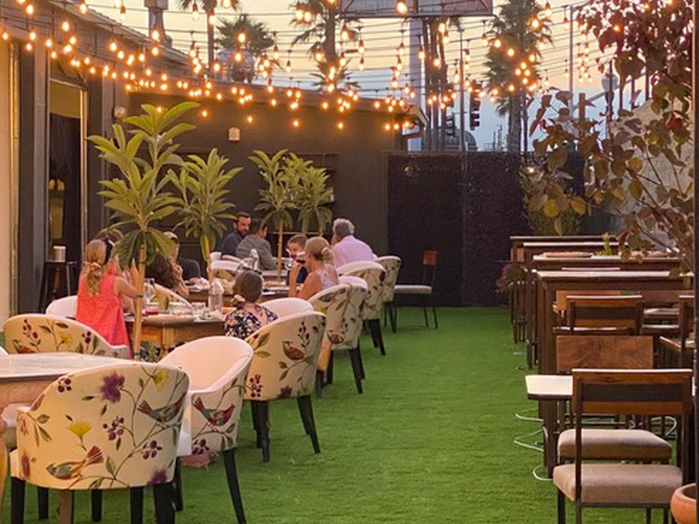 Outdoor dining space at The Kitchen @MCASD with string lights, perfect for events.