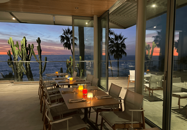 Elegant event space with ocean view at sunset, perfect for upscale dinners and gatherings.