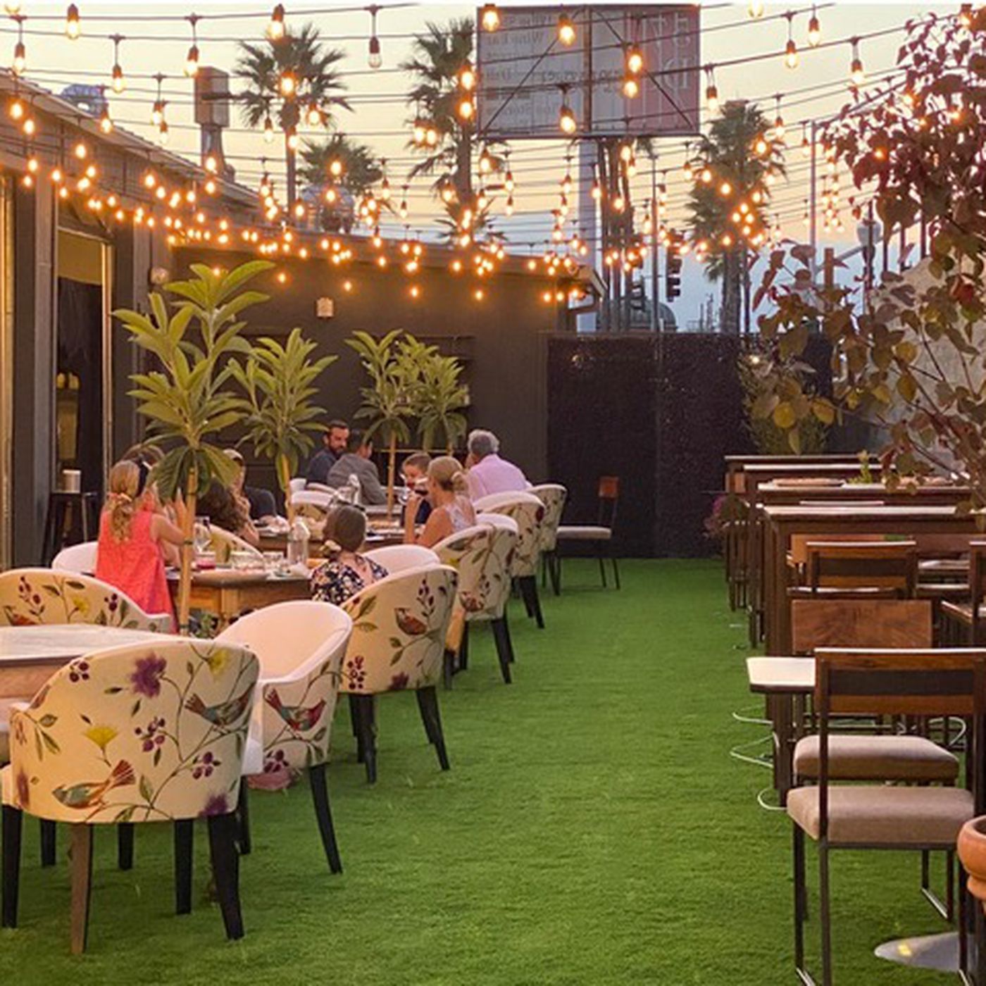 Charming outdoor dining space with string lights for intimate gatherings and events.