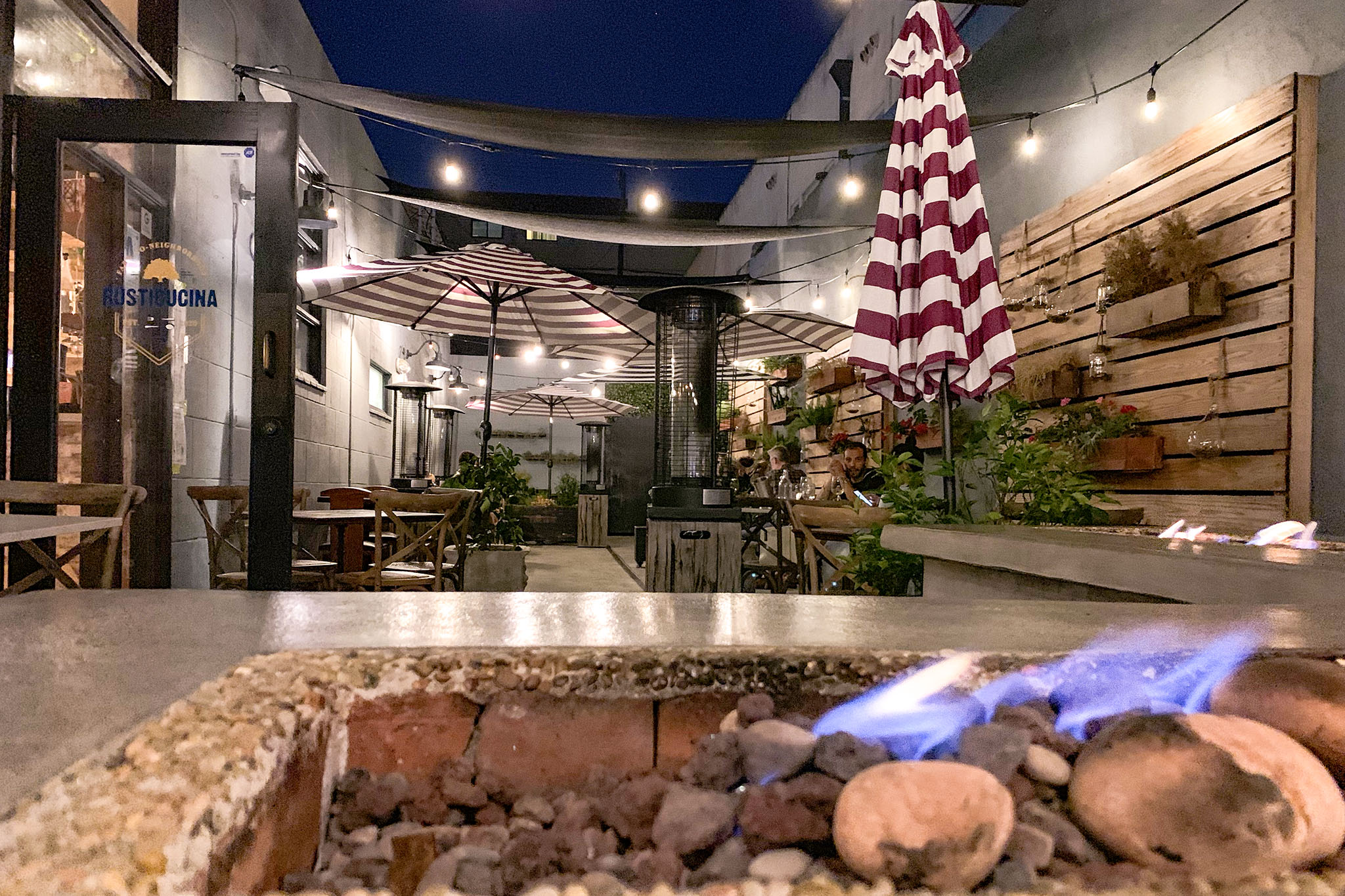 Charming outdoor event space with fire pit, perfect for networking and receptions.