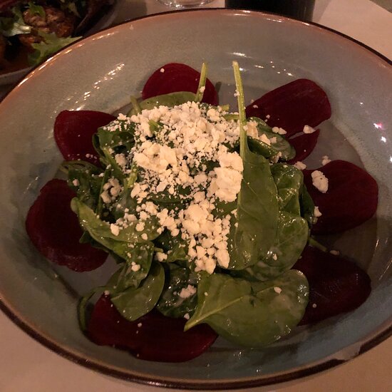 Plated salad with spinach, beets, and feta for upscale event catering.