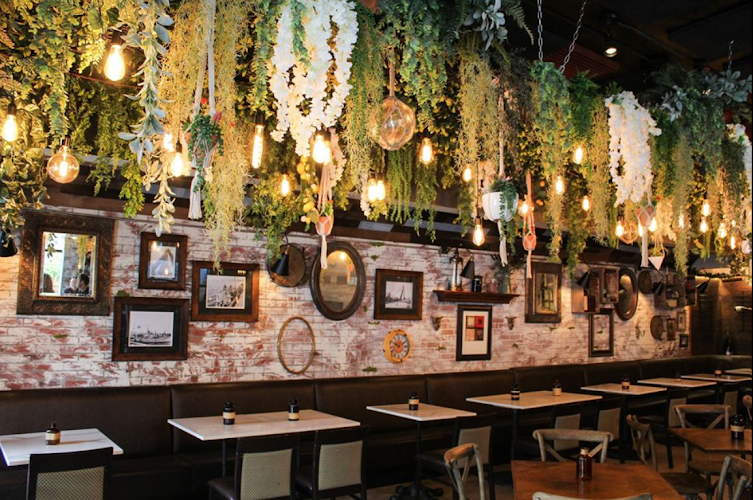 Charming Rusticucina restaurant with lush greenery, perfect for gatherings and events.