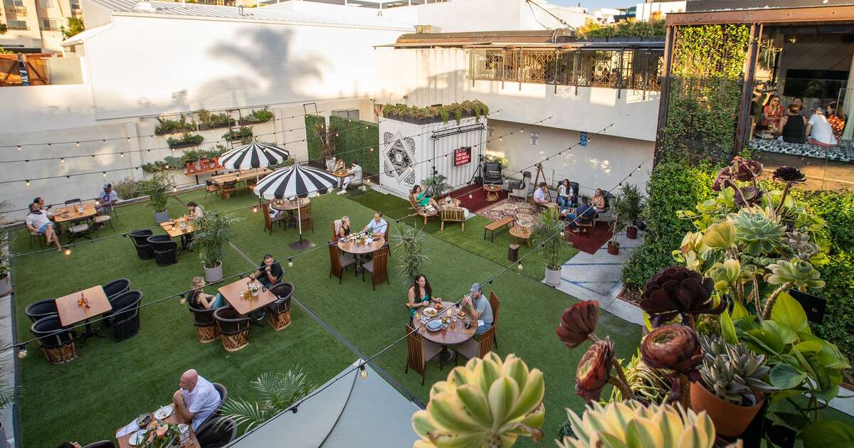 Rooftop patio at Kettner Exchange, lush greenery for casual gatherings and networking.