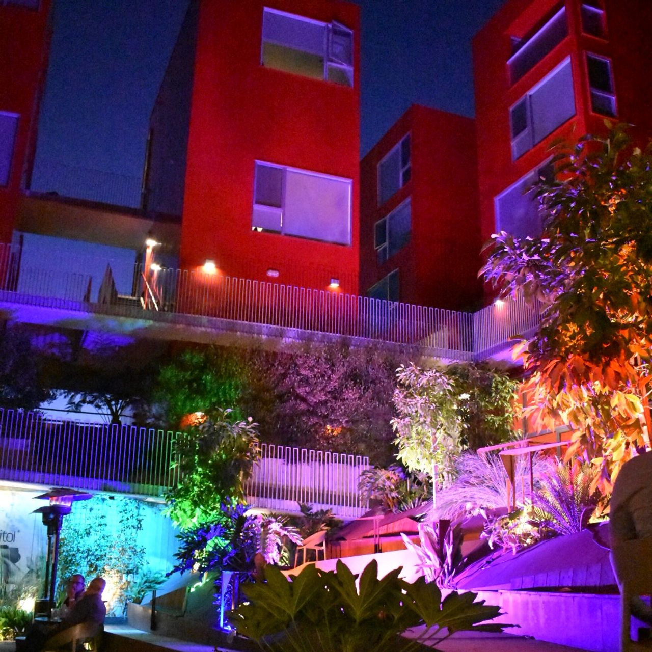 Vibrant outdoor lounge with colorful lighting, perfect for evening networking events.