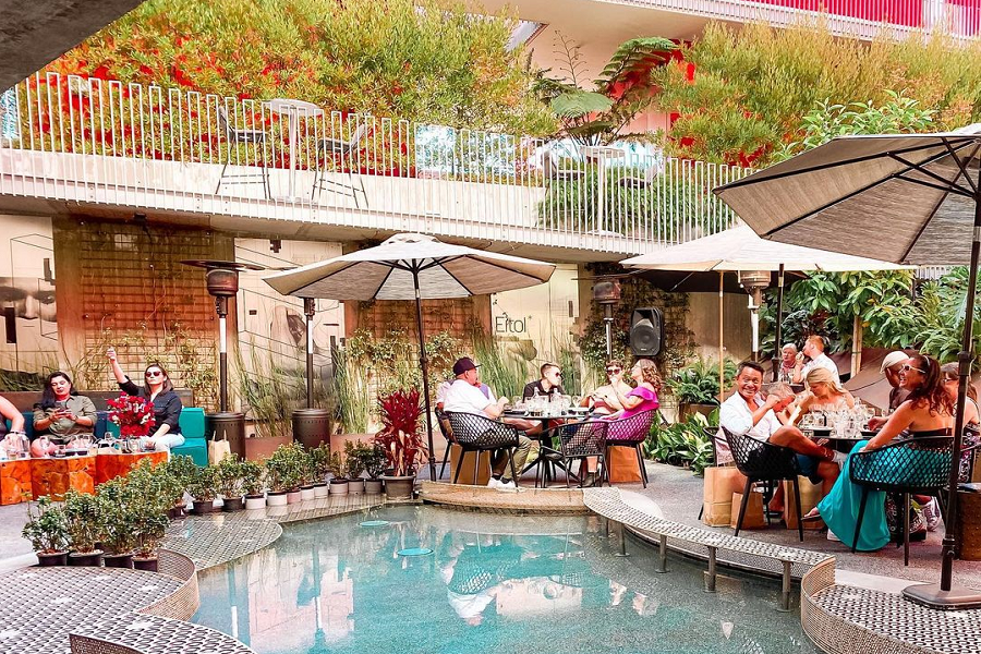 Vibrant outdoor dining venue with lush greenery for casual networking events.