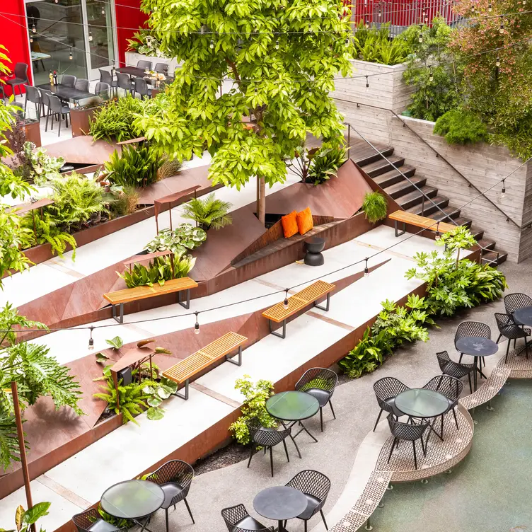 Main Dining Room at insideOUT: tiered seating in a lush outdoor event space.