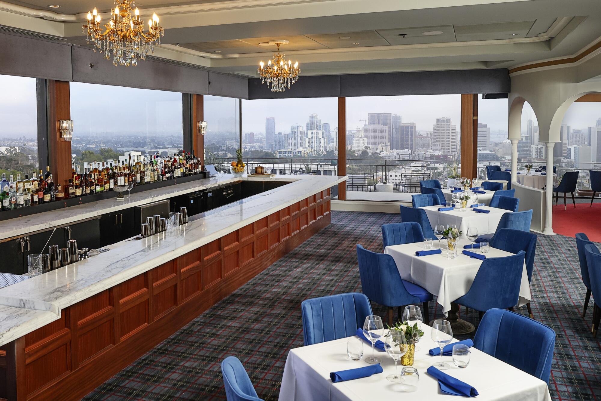 Formal dining area at Mister A's Restaurant with elegant tables and city views for upscale events.