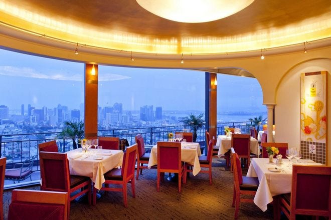 Elegant dining area at Mister A's Restaurant with city views for corporate dinners.