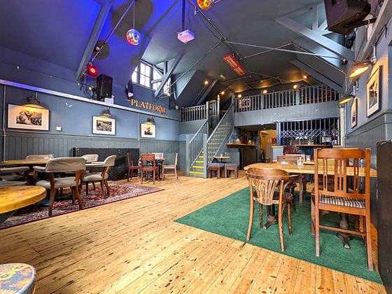 Versatile event space at The Railway Inn with rustic decor, ideal for gatherings and meetings.