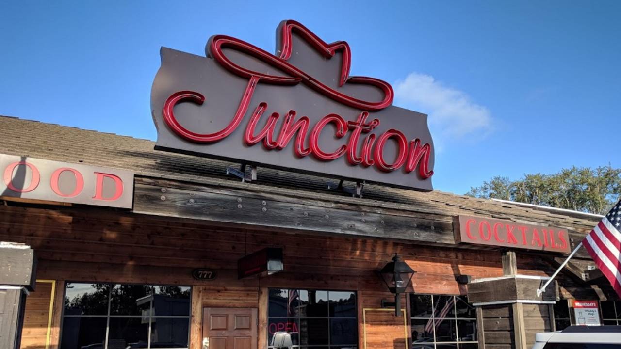 Rustic Scripps venue with neon "Junction" sign, perfect for casual events and gatherings.