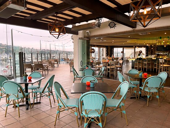 Stylish waterfront venue with turquoise seating for events at Vessel Restaurant + Bar.