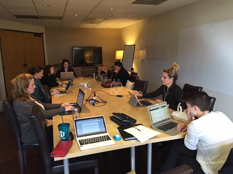 Brown Meeting Room at Hera Hub: collaborative space with laptops for productive team discussions.
