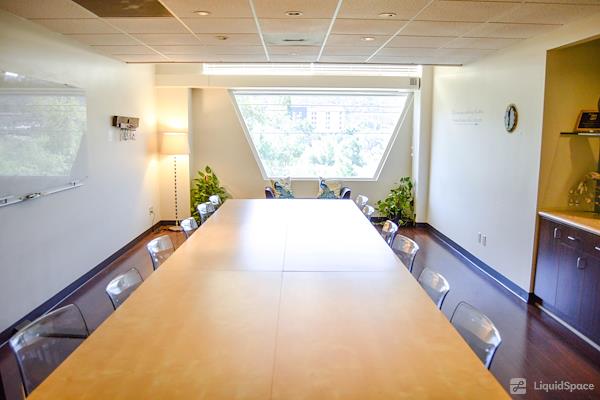 Modern Mission Valley meeting room with large table, ideal for collaborative sessions.