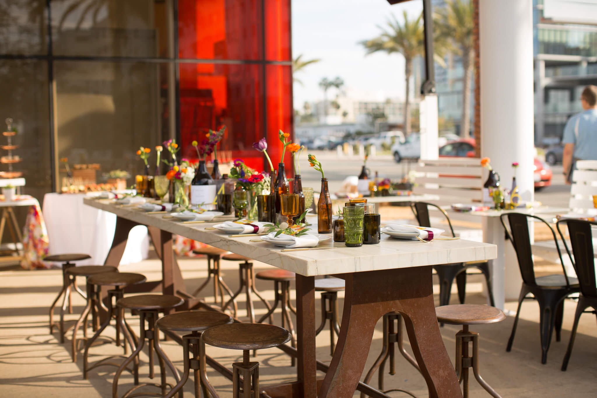 Elegant outdoor dining setup with floral centerpieces for private events.