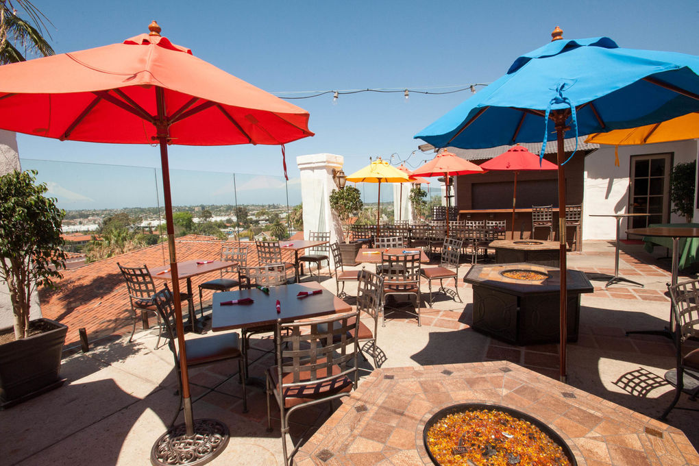 Vibrant outdoor event space at Old Town Tequila with colorful umbrellas and cozy fire pit.