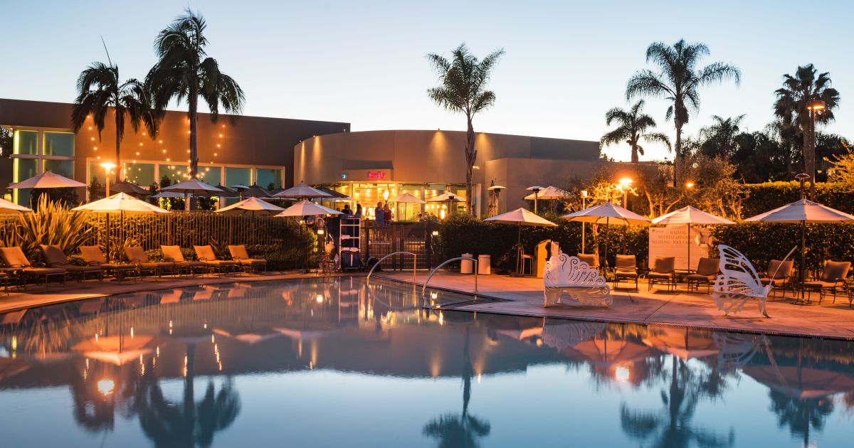Tropical Courtyard pool at dusk, perfect for outdoor events and gatherings.