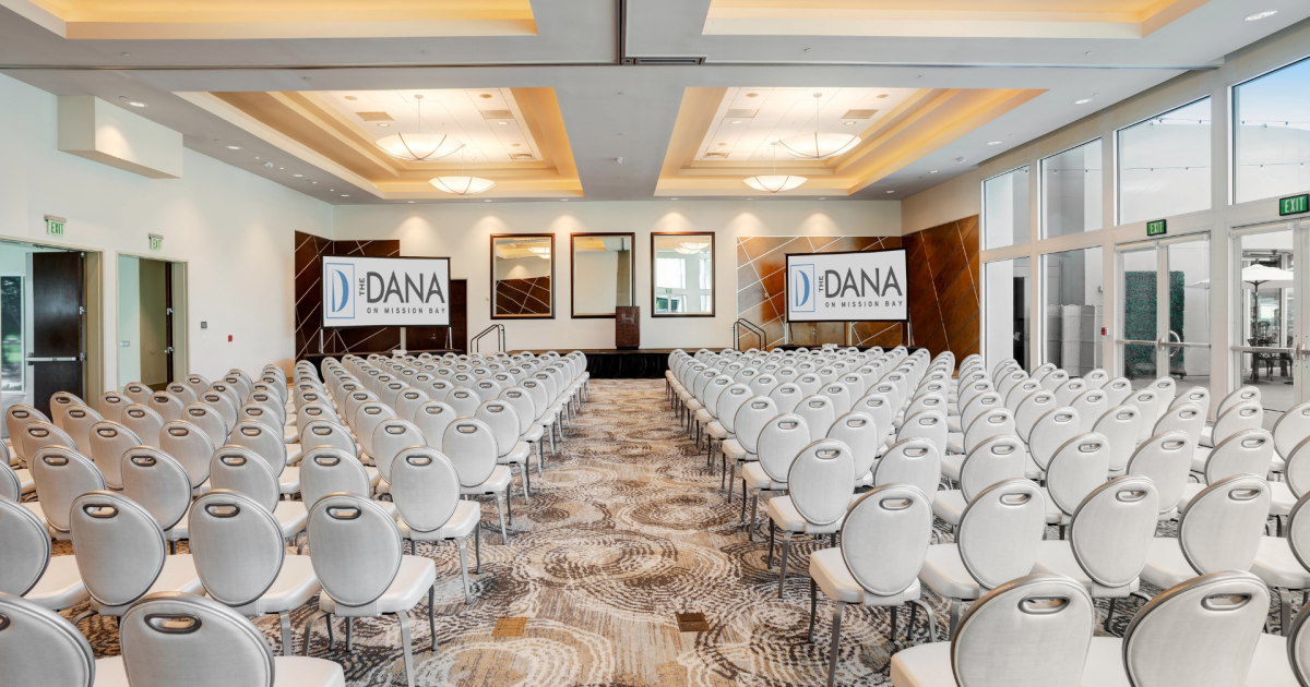 Modern conference room with arranged chairs and large screens at The Dana on Mission Bay.