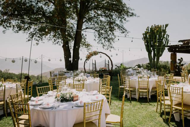 Elegant outdoor wedding venue with round tables and scenic backdrop in San Diego.