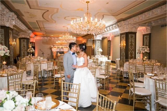 Elegant wedding reception in San Diego with gold chiavari chairs and floral centerpieces.
