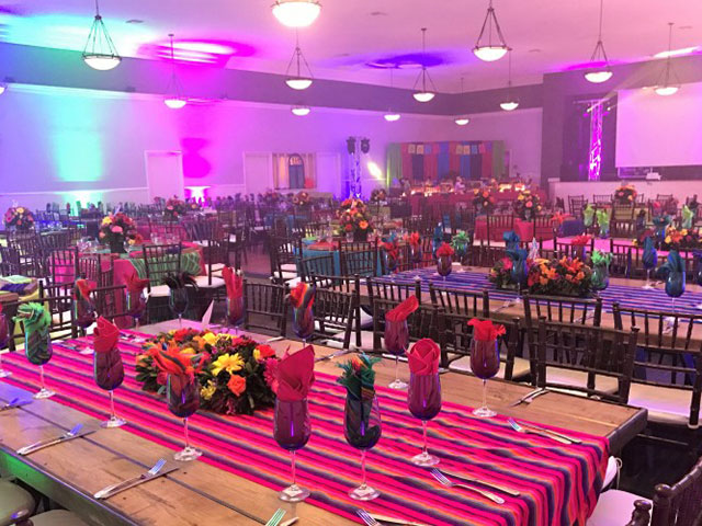 Colorful ballroom setup with floral arrangements for festive gatherings in Swiss Park Event Hall.