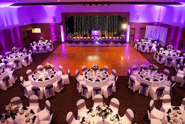 Elegant wedding setup with floral centerpieces in Swiss Park Event Hall.