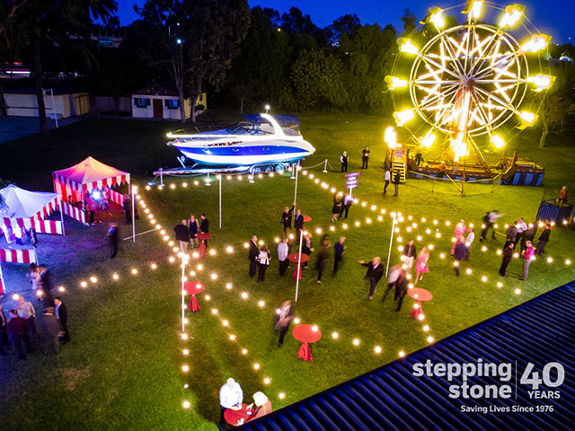 Vibrant outdoor event at Swiss Park with string lights and a ferris wheel for celebrations.
