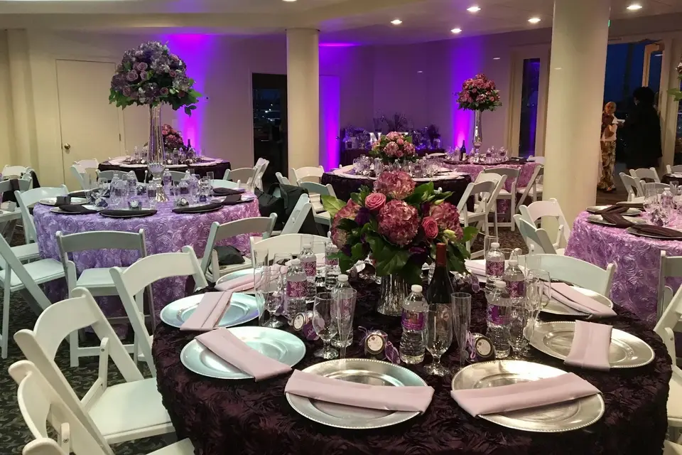 Elegant event space at Bayside Pavilion, perfect for weddings with floral centerpieces.